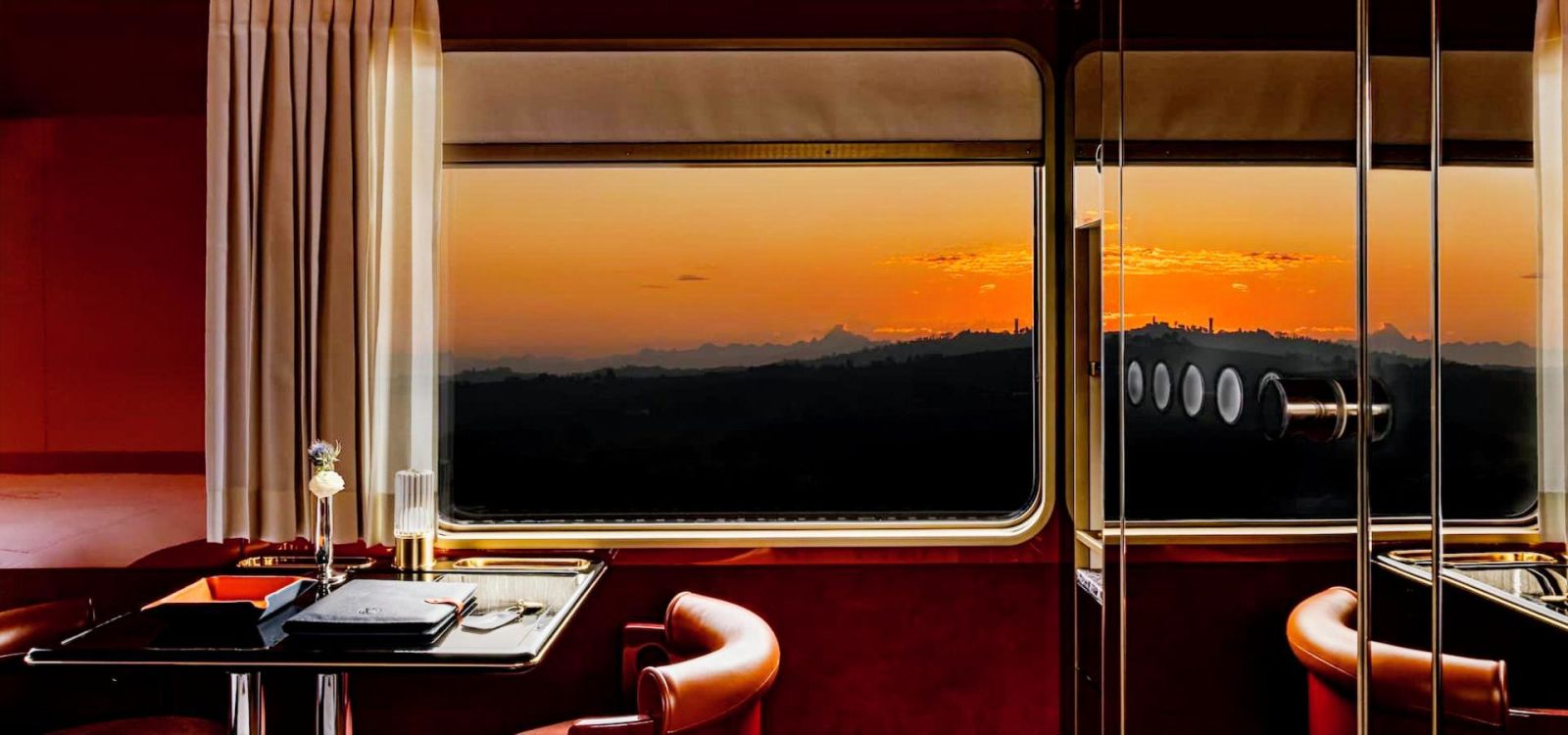 Suite cabin with double bed, warm lacquer tones and artwork